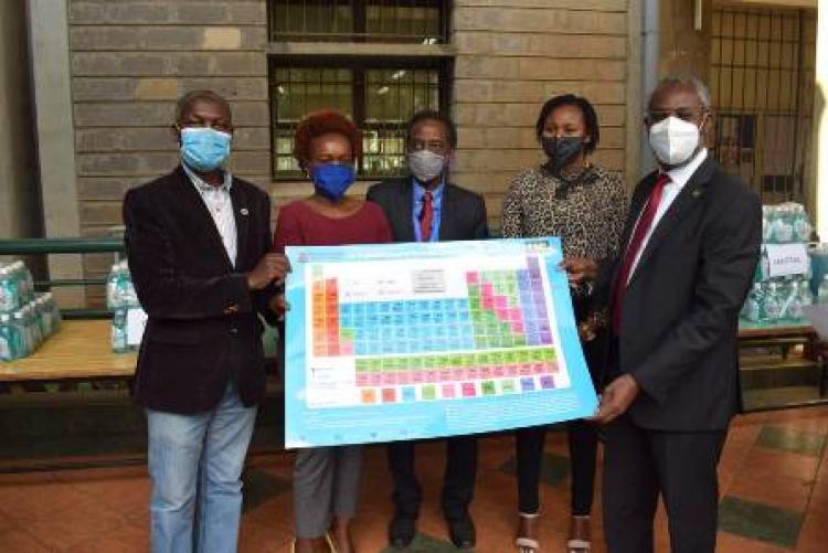 VC, handing over periodic table to the College of Health Sciences