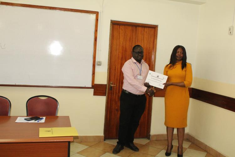 Dr. F. Mwazighe receiving his certificate