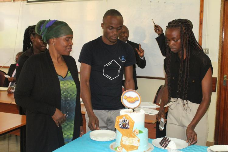 Presentation of the cake by UNICSA students