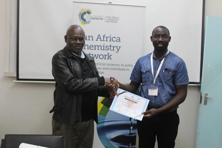 Participant from Uganda being presented with the certificate of participation