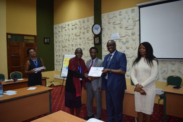 Participant receiving certificate during the closing ceremony of the training