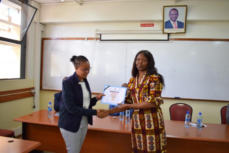 Dean, FST awarding the participant the certificate of participation