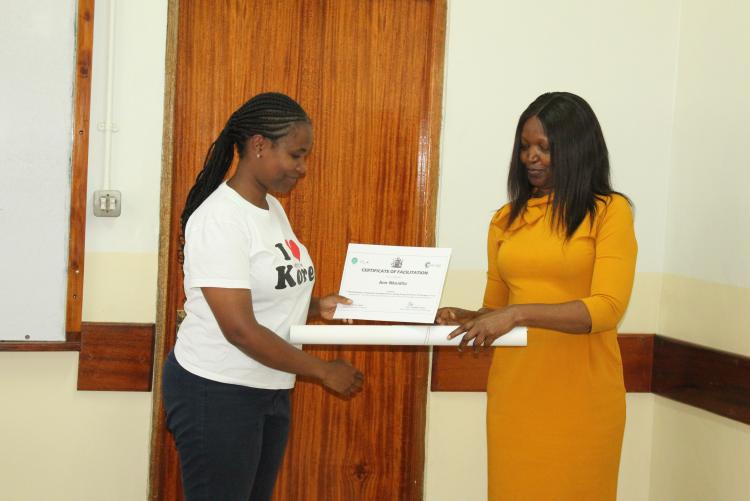 Ms. Anne from Advancement  receiving her certificate