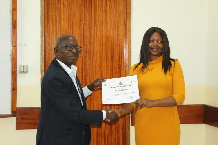 Dr. Njagi Njomo receiving his certificate