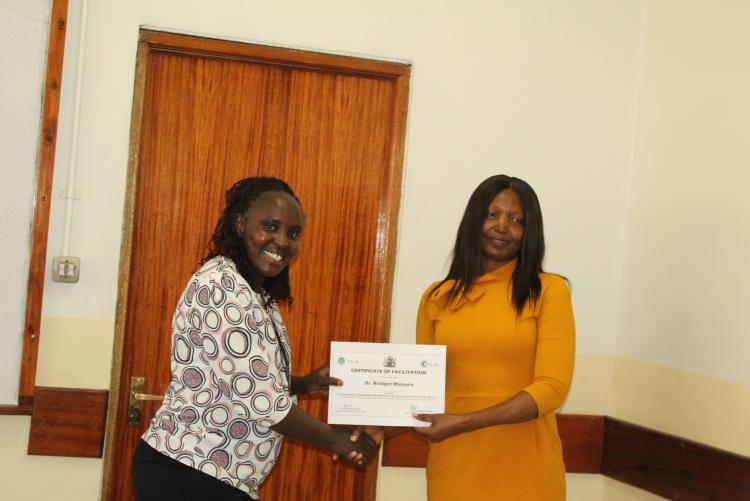 Dr. Bridget Mutuma receiving her certificate