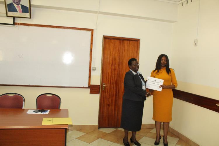 Dr. I. Michira receiving her certificate
