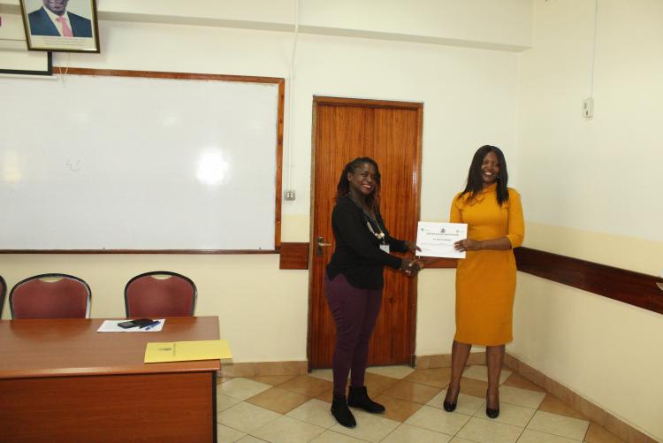 Dr. R. Njogu receiving her certificate