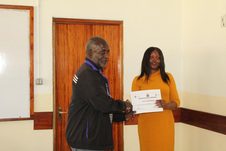 Prof. Kithinji receiving his certificate