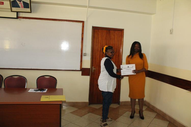 Dr. Mbui receiving her certificate