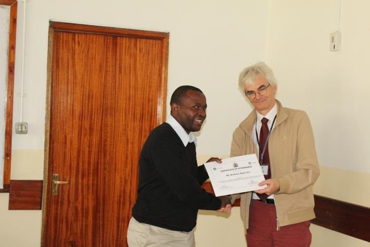 Mr. Sirr Nicholas receiving his certificate
